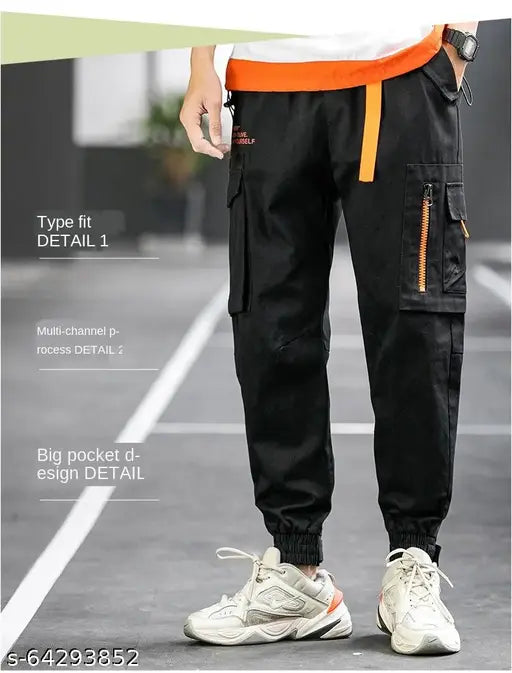 Men's black cotton cargo pants with elastic waist and drawstring, featuring flap pockets and zip details, in army green color