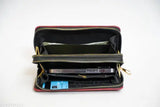 A black clutch purse with a zip closure