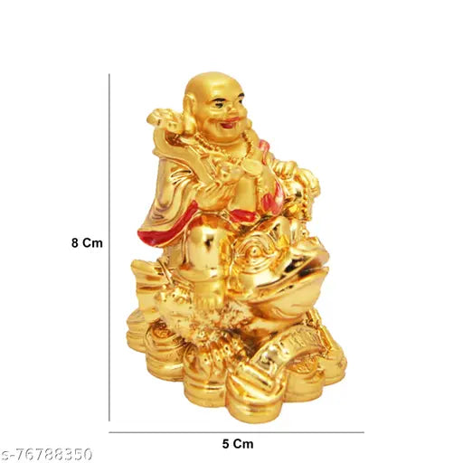 Gold figurine of a laughing Sidak Buddha sitting on a frog, with money coins beneath it