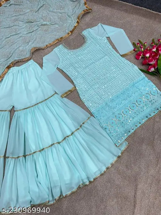 Teal, gold trimmed traditional Indian dress set consisting of a top, bottom, and sharara