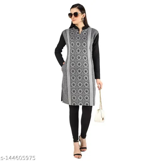 Woman standing, wearing sunglasses, black and white patterned kameez and leggings, with handbag