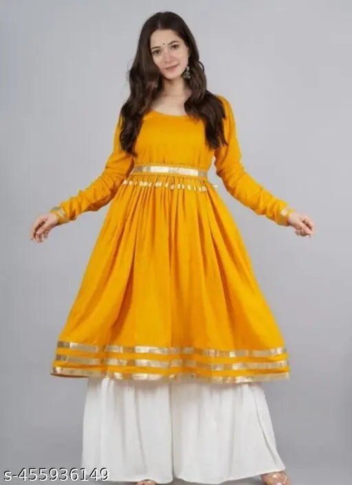 Yellow long kurta with embellished border and pallu, paired with matching chudidhar