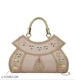 Pink embellished satin clutch with multiple decorative elements, possibly crystal or sequin detailing