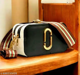 Black leather sling purse, brown striped trim, gold metallic logo, 3 card slots