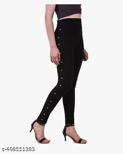 Black cotton blend jegging, embellished with stones for teenagers on display stand