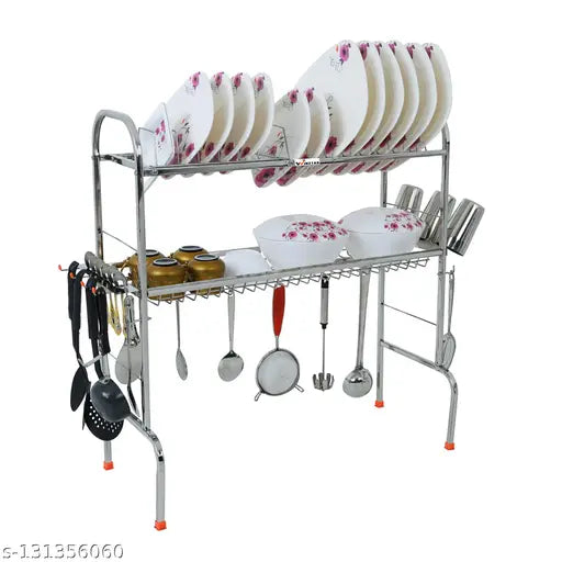 Stainless steel over sink dish drainer rack, with multiple bowls on its side and various kitchen utensils hanging from it. Space-saving design for drying dishes, featuring a plate cutlery stand and a kitchen organizer. Dimensions: 30 inches long x 26 inches wide. A multipurpose kitchen accessory for maximizing countertop space