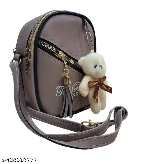 Sleek silver sling bag with teddy bear and zip closure