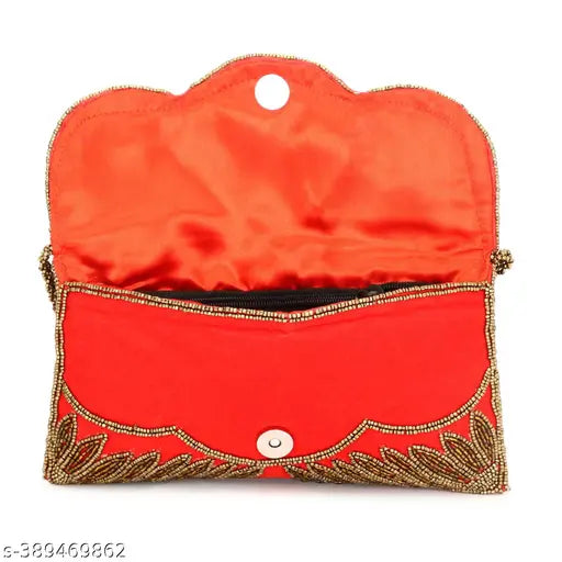A women's red clutch with embroidered accents and a gold zip closure