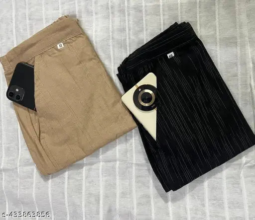 Brown twill trousers, two pairs, hanging from a rack with tags and labels
