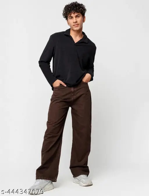 A man wearing a dark turtleneck, brown oversized baggy jeans