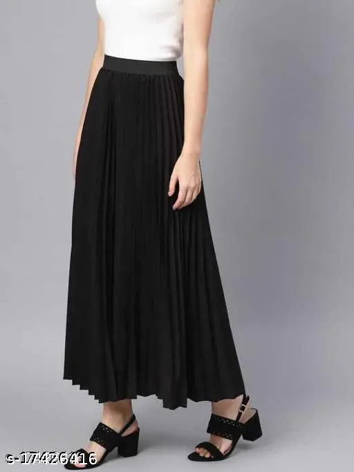 Black pleated skirt on a woman standing against a light background