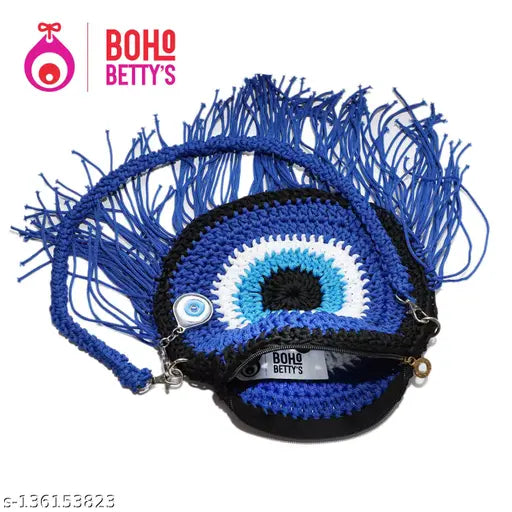 Black fringed sling bag with an intricate evil eye design