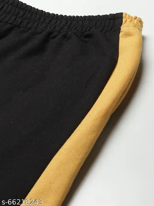 Black, white, and yellow track pants with a zipper fly