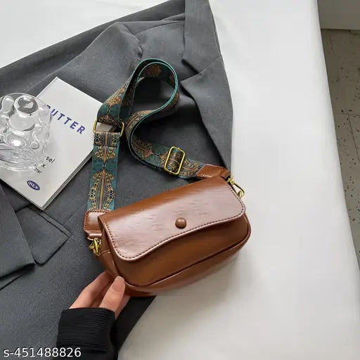 Black leather crossbody bag with a small wallet pocket