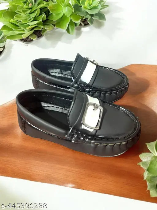 Black loafer shoes with white accents, straps
