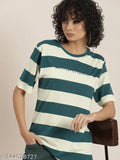 A person wearing a multicolored striped oversized T-shirt