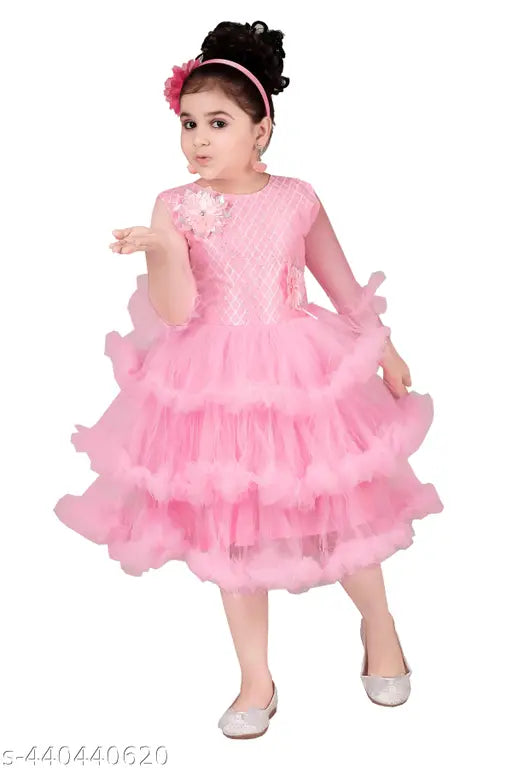 Pink tulle party dress with ruffled sleeves, black satin sash, and sequins on the bodice