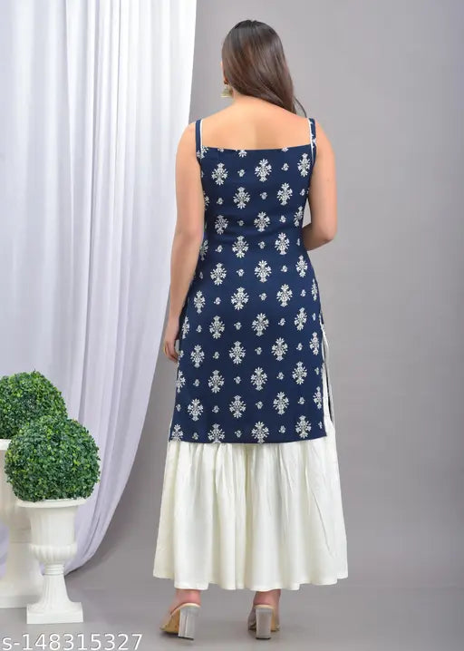A woman wearing a blue and white straight kurta with sharara set