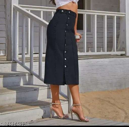 Black denim skirt with buttons, worn by woman standing outside