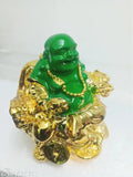 Green laughing Buddha home decor, sitting on a sofa