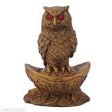 Synthetic resin Vastu owl statue sitting on gold Yuan Bao, symbolizing wealth and prosperity in Indian feng shui and Hinduism