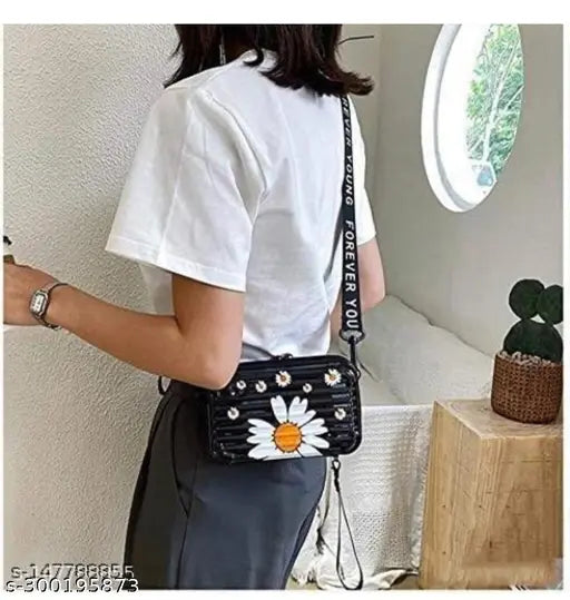 Miniature side purse with a black floral pattern, shoulder straps and a hand strap