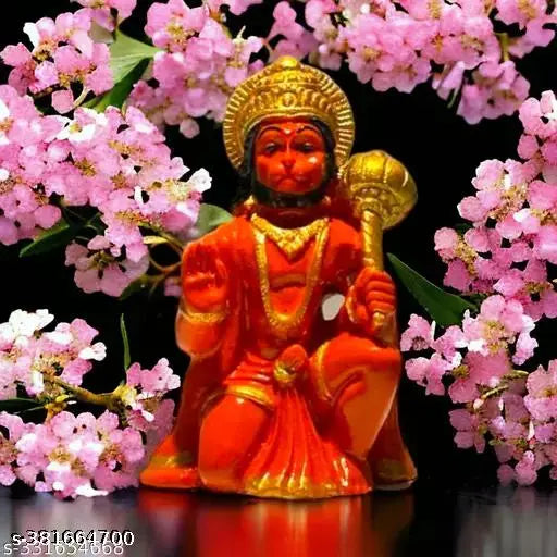 Orange statue of Lord Hanuman with a drum