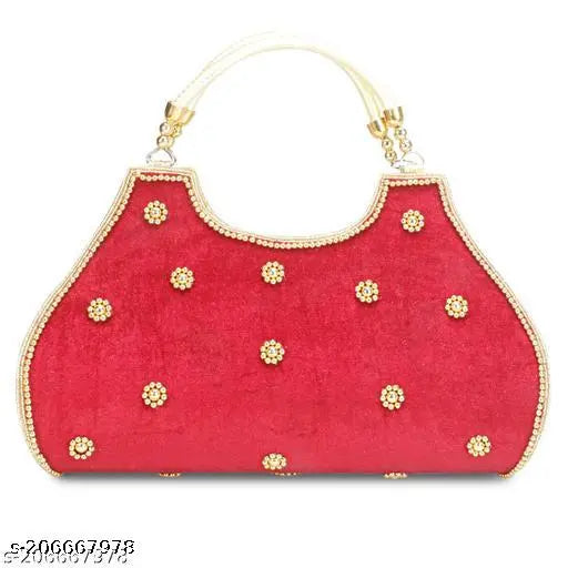 Red faux leather clutch with dotted embellishments and two large golden clips