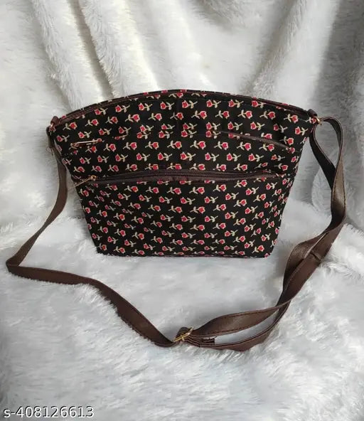 The image shows a stylish sling bag with five visible chains, designed by ikkat. It features a red floral pattern and is presented against a neutral background. The bag appears to be made of leather or a similar material
