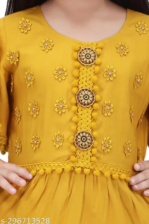 Yellow rayon frock with decorative floral embroidery on a child's mannequin