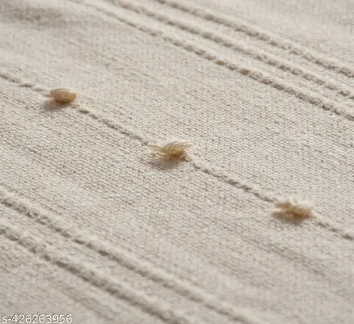 Beige cotton throw with a loop fringe for sofa or bed
