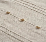Beige cotton throw with a loop fringe for sofa or bed