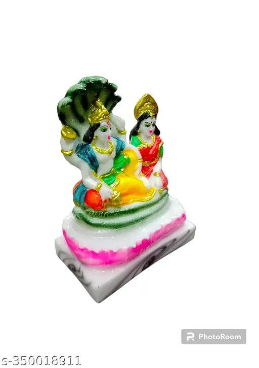 Golden idol of Lord Vishnu and Goddess Laxmi, 5 inches tall with green and pink embellishments