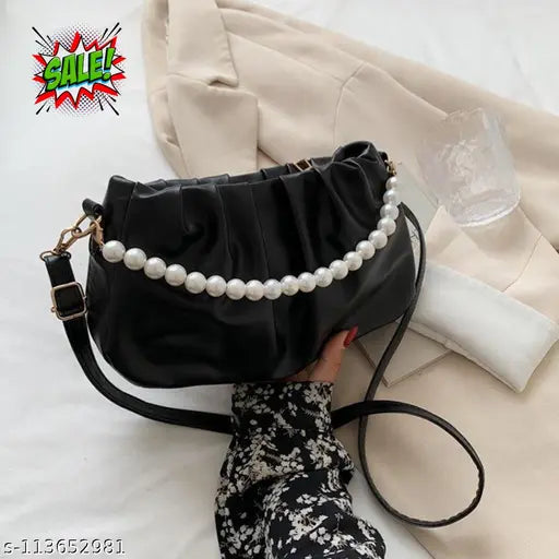 Trendy black leather slingbag with pearl accents and a matching pearl necklace