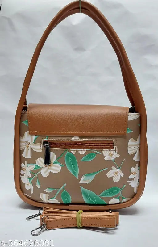 Slender, tan crossbody with a floral print, featuring a brown leather strap and a small pocket on the front