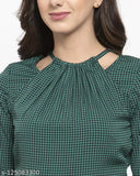 Women's green and black houndstooth print crepe jumpsuit with three-quarter sleeves, halter neck design on model
