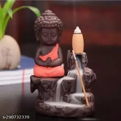 A meditating monk figurine on a fountain, handcrafted polyresin, orange color. Includes a free incense cone set