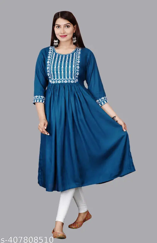 A woman wearing a blue kameez with white embroidery