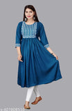 A woman wearing a blue kameez with white embroidery