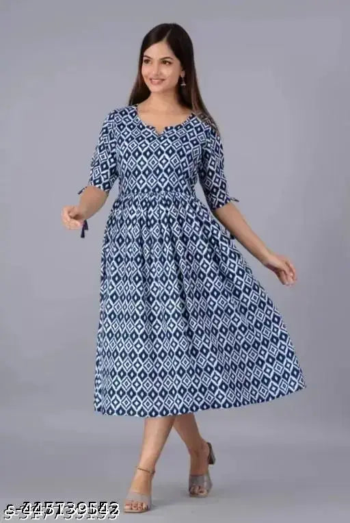A woman wearing a long, blue and white patterned kameez with 3/4 sleeves