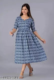 A woman wearing a long, blue and white patterned kameez with 3/4 sleeves