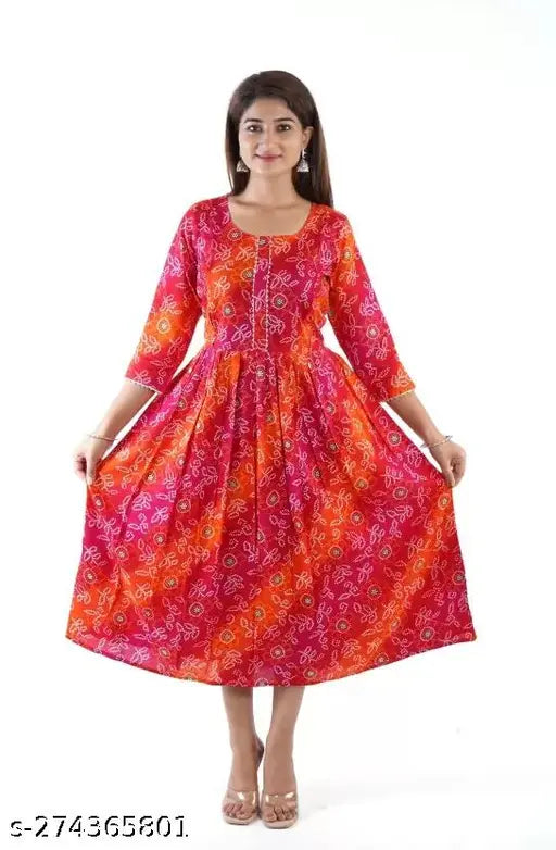 A woman posing in a long, vibrant pink maternity kameez with a zipper feeding into a matching kurta