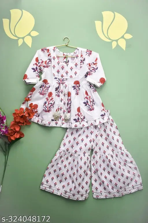 White floral print cotton kurti-Sharara set with gota detailing, A-line top and sharara bottom. Soothing white color, three-quarter sleeves, and elastic waist. Traditional ethnic look for girls aged 6 months to 9 years, Indian origin