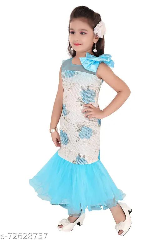 A young girl in a blue mermaid dress with ruffles