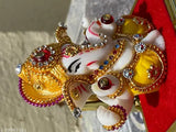 Multi-colored polyresin Ganesha idol for home decor and car dashboard, handcrafted with religious symbolism for Diwali gifting or room decoration