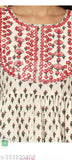 A woman's red and black patterned blouse with a V-neck