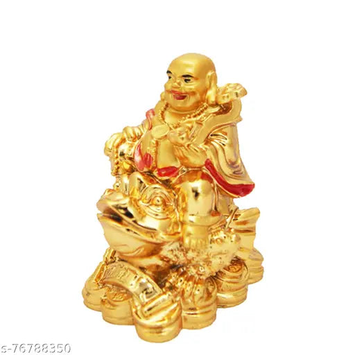 Golden laughing Buddha figurine sitting on a frog, holding money coins, symbolizing health, wealth, and prosperity