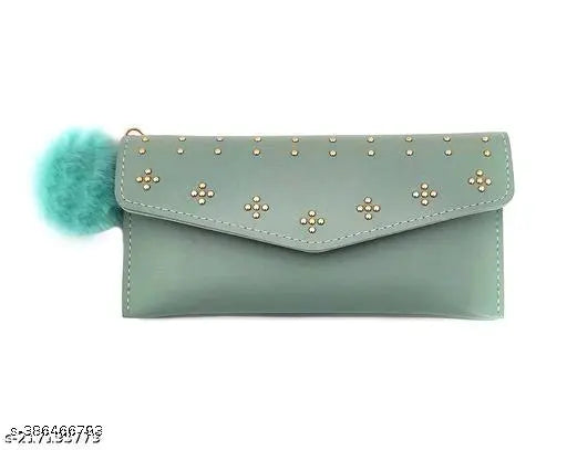 Teal blue clutch purse with multiple gold studs and a fuzzy pompom