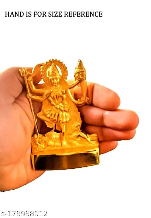 Metal idol of the Hindu goddess Durga, holding a trident and standing on a single leg