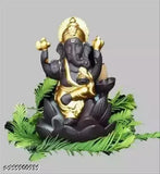 Black, gold, and silver metal religious figurine with backflow incense holder, set against natural greenery